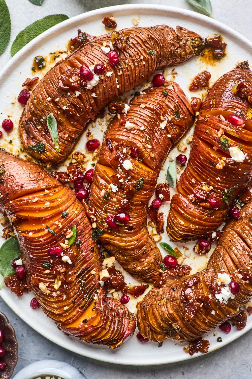 Hasselback sweet potatoes garnished with bacon maple brown butter