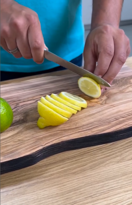 slicing lemons on cutting board with utility knife