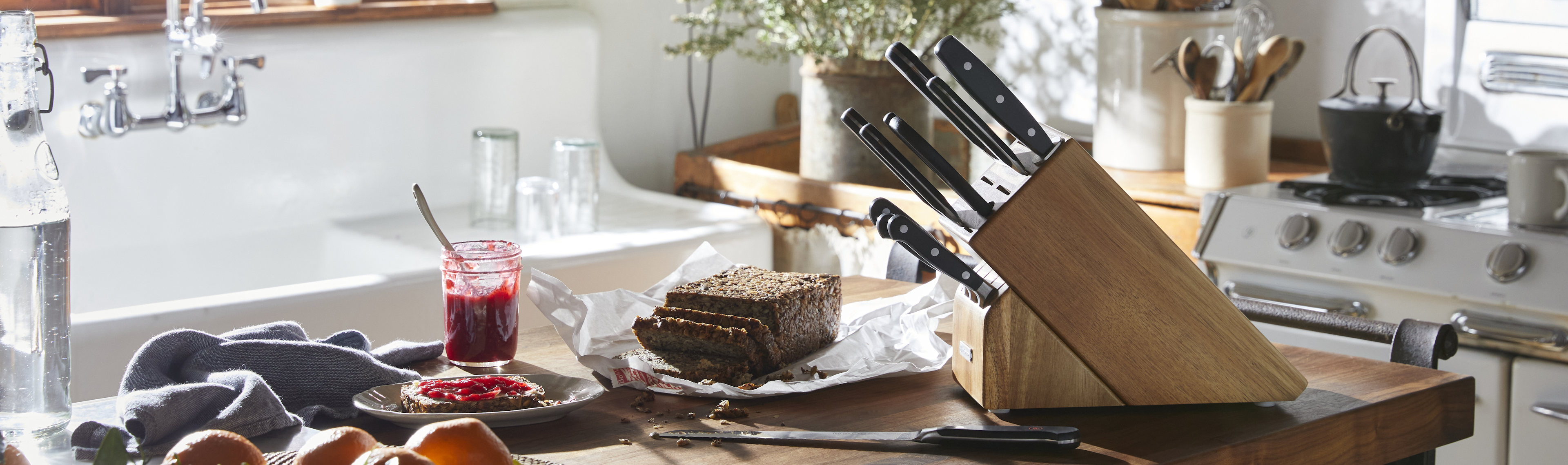 WUSTHOF knife block on a kitchen island surrounded by fresh food.